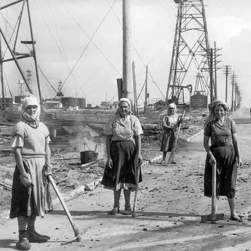 Women engaged in labor in the Balakhany oil fields, Baku, Azerbaijan, showcasing their contributions to the energy sector in a challenging environment.