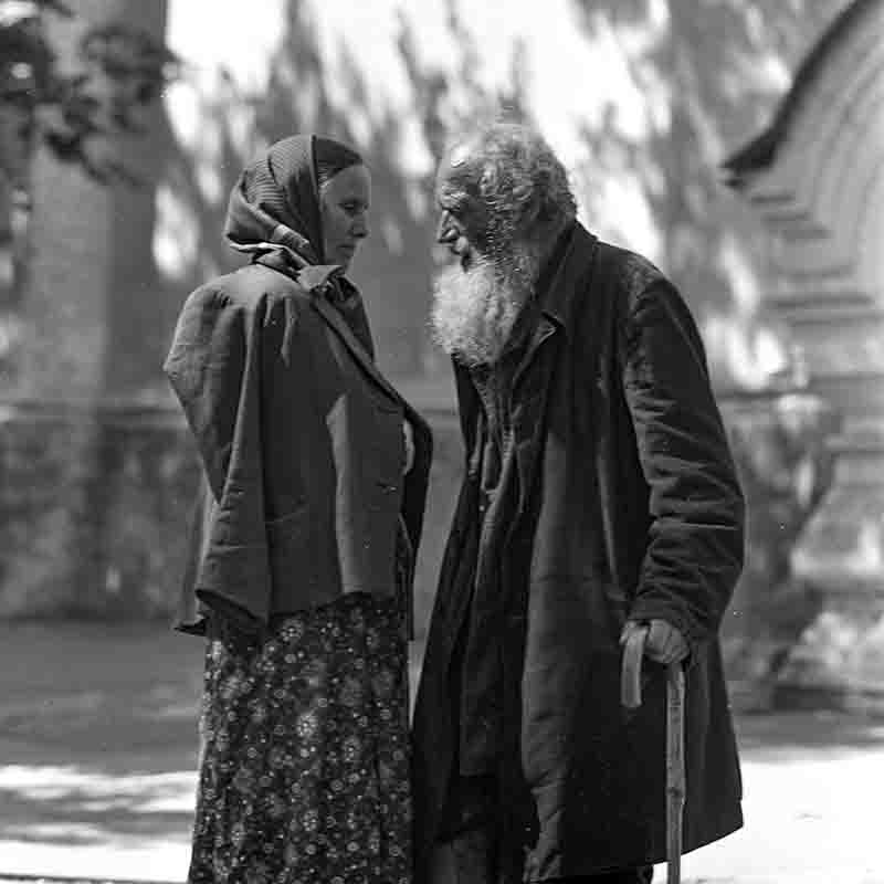 Elderly couple stands together on a street in Tbilisi Georgia.