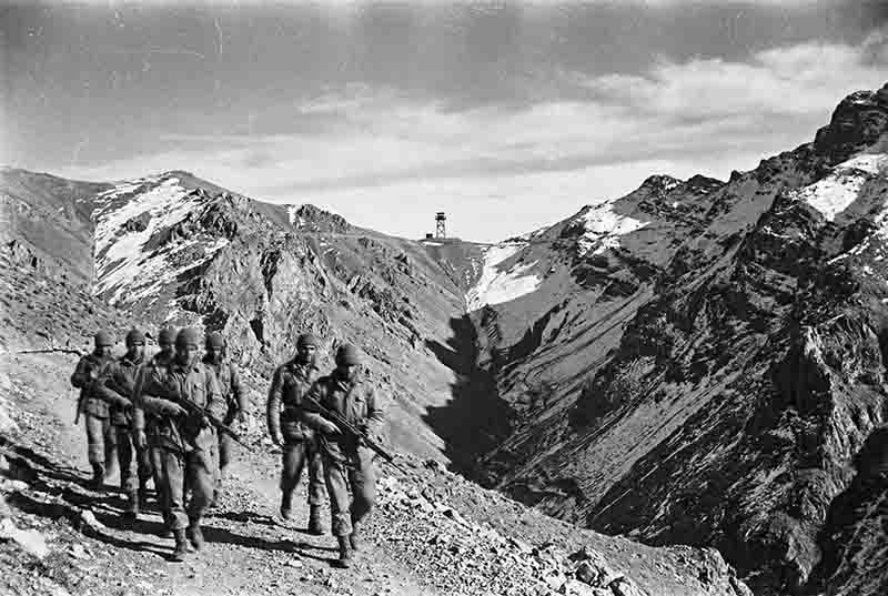 A historical photograph showing the mountainous landscape of northern Iran along the Soviet border, with a military patrol visible — symbolising the strategic tension of the Cold War's Southern Front.