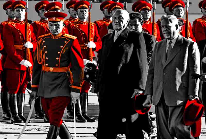 Konrad Adenauer during his 1955 visit to Moscow. To his left, a high-ranking military officer in a detailed red and black dress uniform, complete with a ceremonial sword.