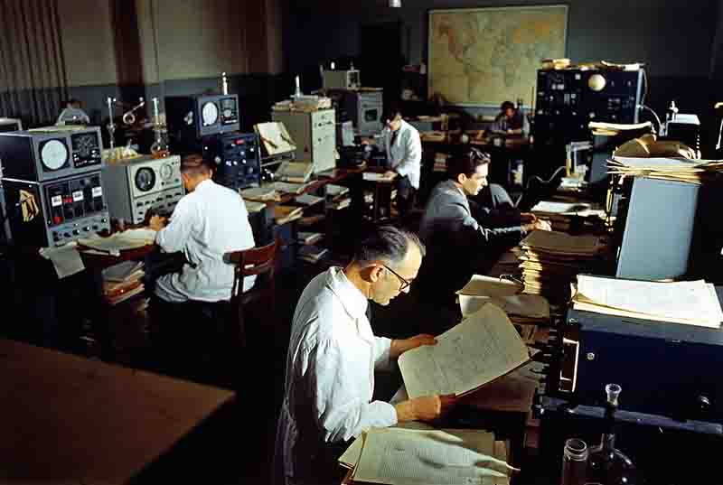 A room filled with early electronic equipment, including oscilloscopes and signal generators, typical of the high-stakes research facilities associated with the Manhattan Project.