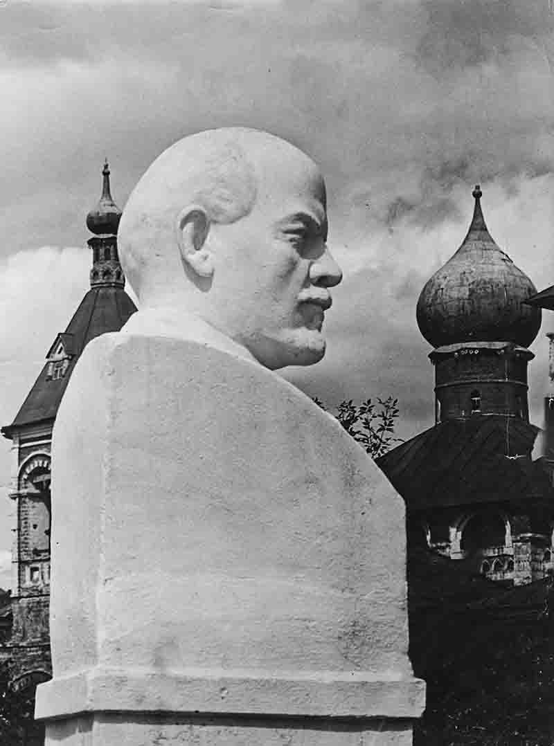 A black and white photograph showcasing a bust of Lenin, highlighting his distinct facial features and historical significance.