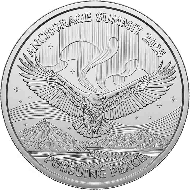 Silver commemorative coin for the 'ANCHORAGE SUMMIT 2025.' The coin features a detailed bald eagle with its wings spread, flying over a mountain range and a body of water. In the background, there is an artistic depiction of the aurora borealis. The words 'PURSUING PEACE' are inscribed at the bottom.